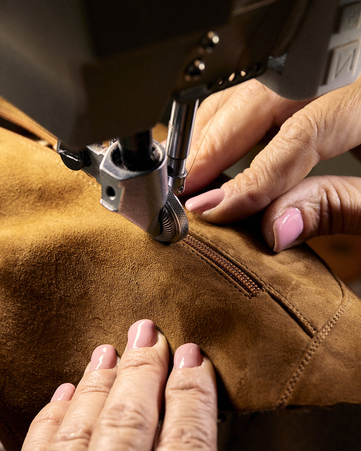 An artisan cutting leather by hand